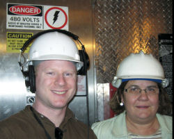 Gabriel Spitzer riding the elevator with neutrino physicist Gina Rameika.