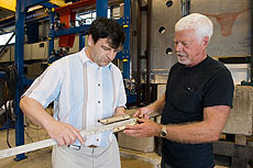 Vladimir Sidorov, a Fermilab Accelerator Division engineer, and Jerry Judd from the Particle Physics Division’s Mechanical Support Department measure a piece of the thingamajig, a device created to help NuMI/MINOS collaborators replace a key piece of equipment. 