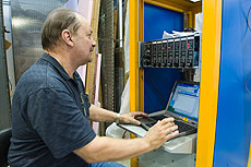 Al Legan of Fermilab's Accelerator Division Controls Department, remotely operates the device. 