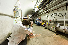 Alignment crew members Randy Wyatt, Scott McCormick and Gary Crutche calibrate newly replaced Tevatron magnet during the 2009 shutdown.