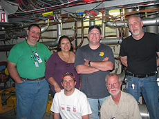 Tevatron mechanical support team members during the 2009 shutdown: Top, from left: Earl Shaffer, Sabina Aponte, Bill Dymond and James Williams. Bottom, from left: Derek Plant and Jerry Szabo. Photo Courtesy of Fermilab.