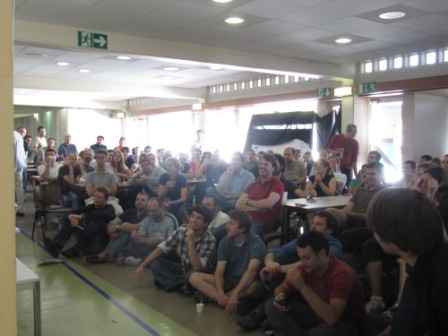 World Cup fans cram into the CERN cafeteria, even sitting on the floor, to get a seat where they can see the game.