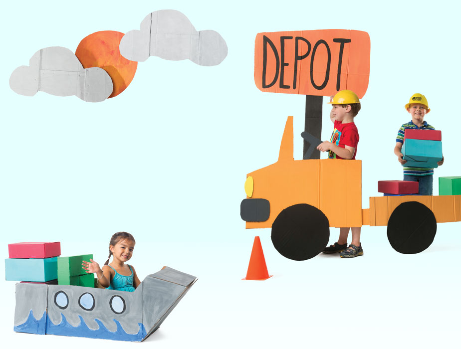 Photo of three children playing with cut-out of truck and shipping container 