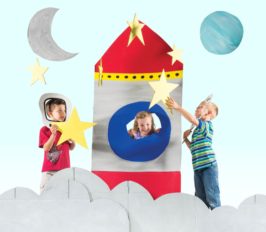 Photo of three children playing with cut out rocket, stars, and planets