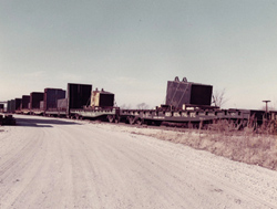 Fermi's magnet arrives at Fermilab by train in 100-ton pieces. 