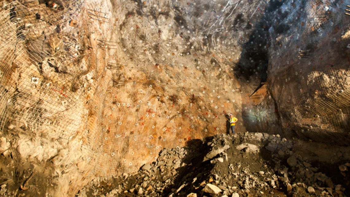 Photo of Wendy Zawada stands on the last pile of rock that needed to be removed from the cavern for the LUX experiment