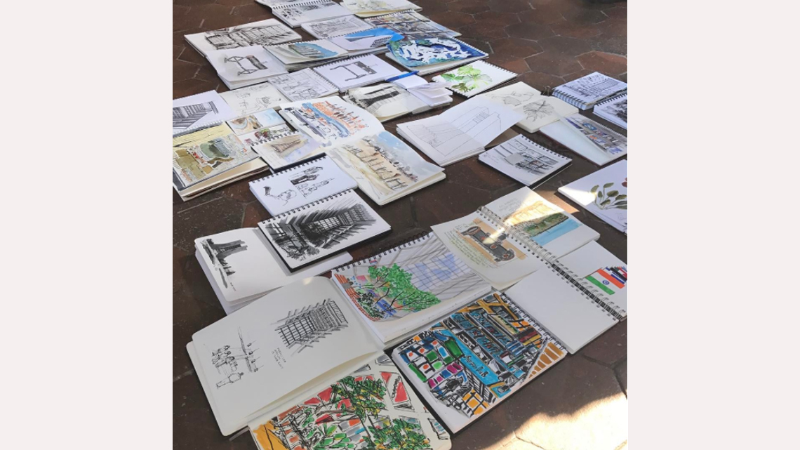 Sketchbooks arrayed on the ground in Wilson Hall