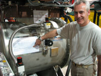 Flavio Cavanna points at an image of the first tracks, taped to the ArgoNeuT detector.