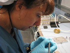 Michelle Jonas examines a one-millimeter square of tape.