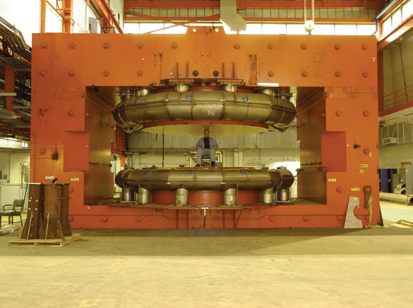 Graduate student Tim Koeth sits between the poles of the Chicago Cyclotron Magnet a few months before the magnet was dismantled. The space in the building will be used for research and development related to the proposed International Linear Collider.