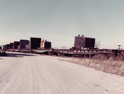 Fermi's magnet arrives at Fermilab by train in 100-ton pieces.