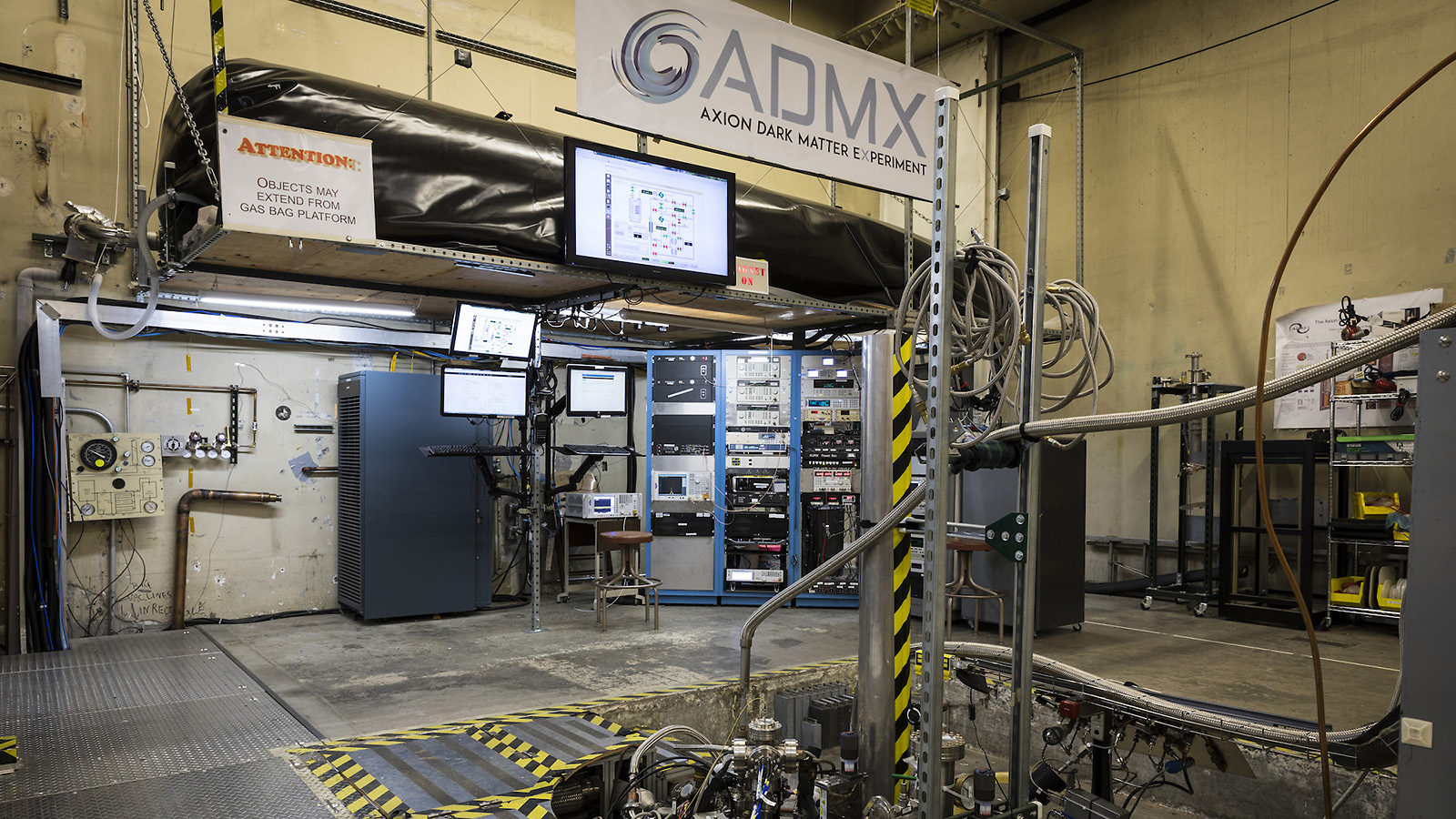 Photo of equipment and panels for the ADMX experiment fill the room: an ADMX experiment banner hangs above