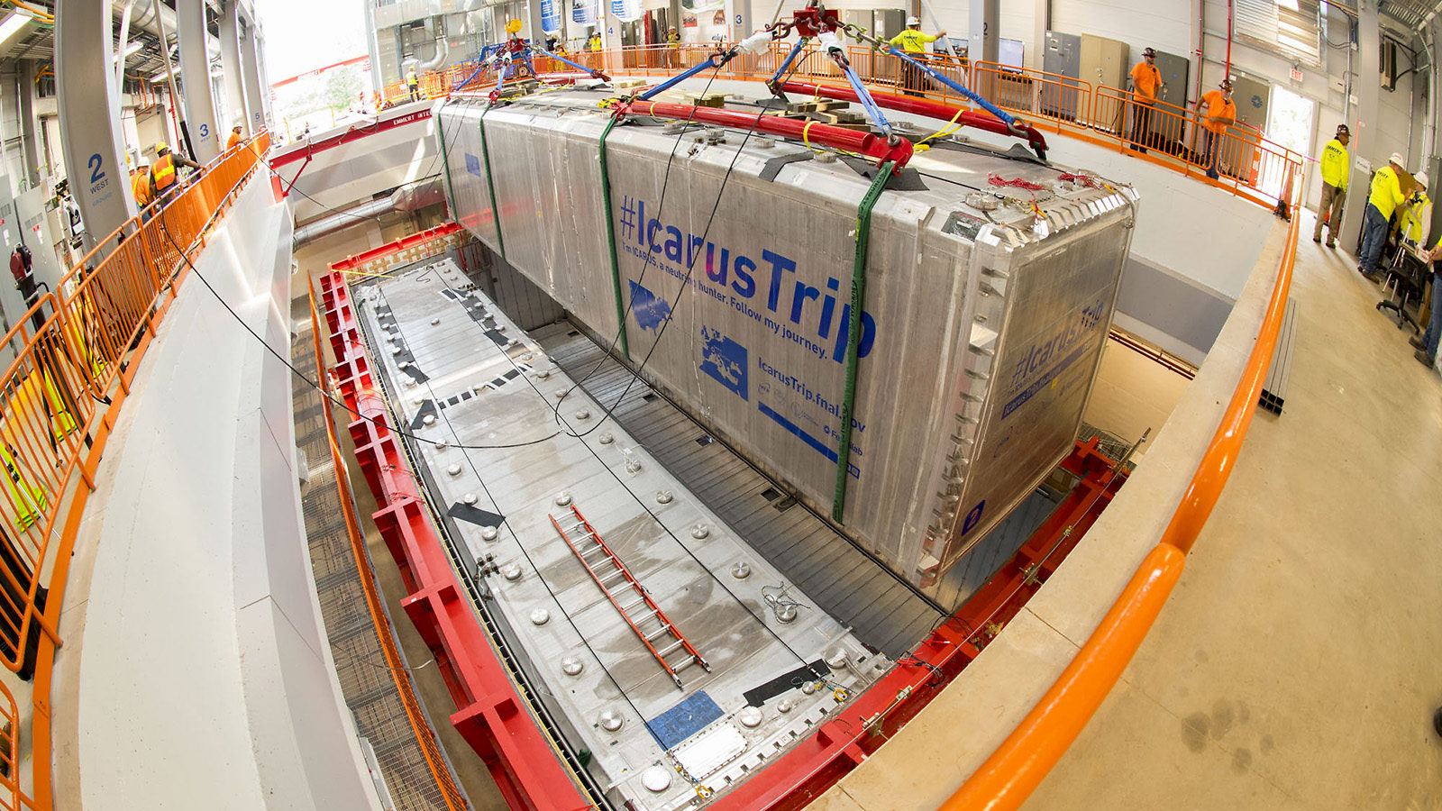 The second silver module of the ICARUS detector is lowered into its container.