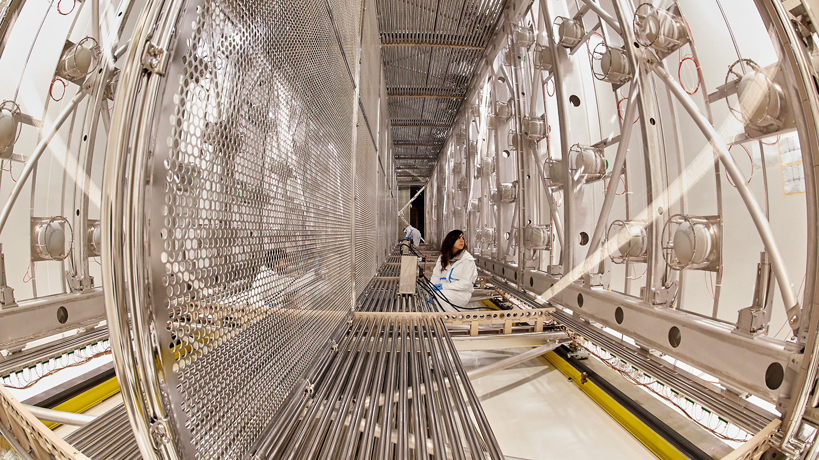 Scientists work inside the empty ICARUS detector