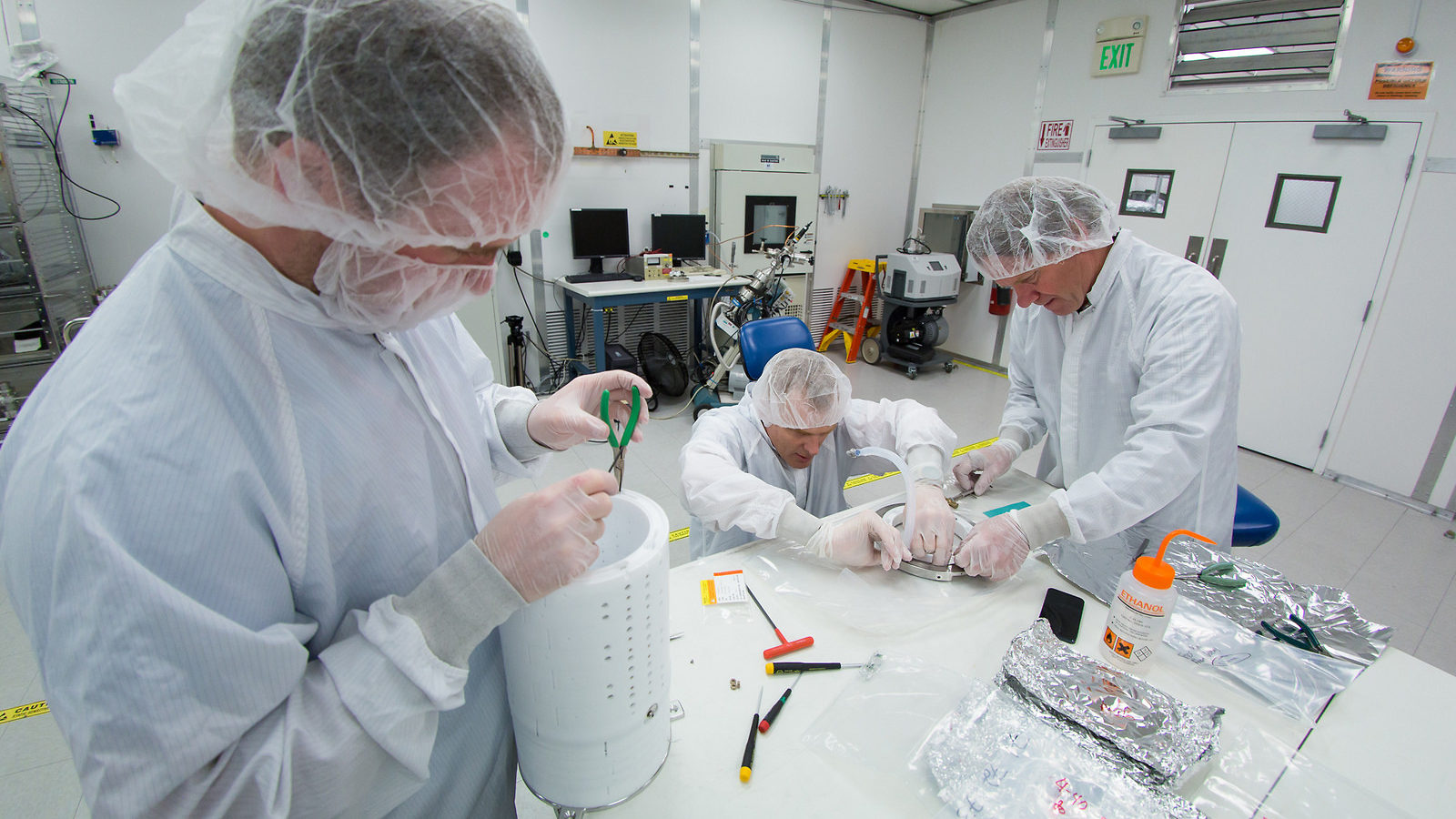 Scientists in a cleanroom assemble the prototype for the LZ detector’s core.