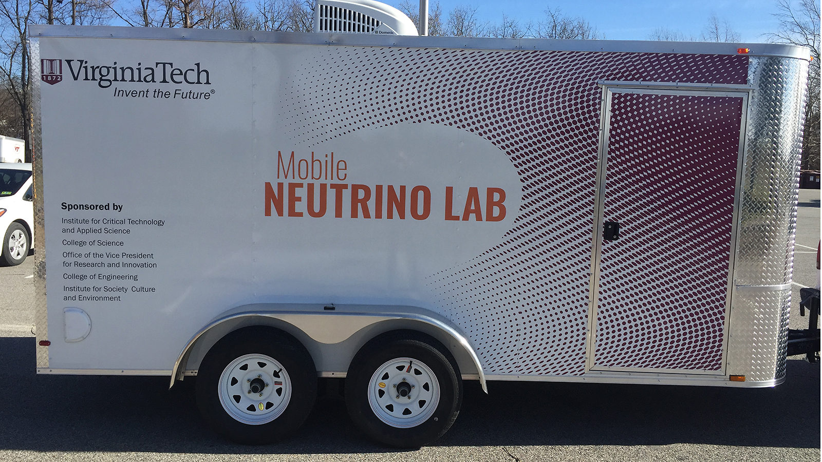 White trailer with the words "Mobile Neutrino Lab" on the side