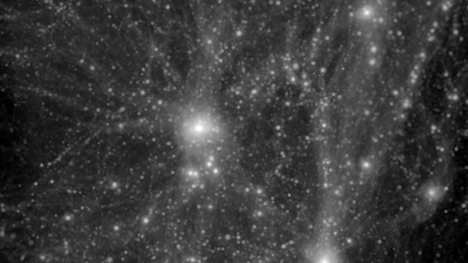 Black and white still from a simulation of galaxies forming 