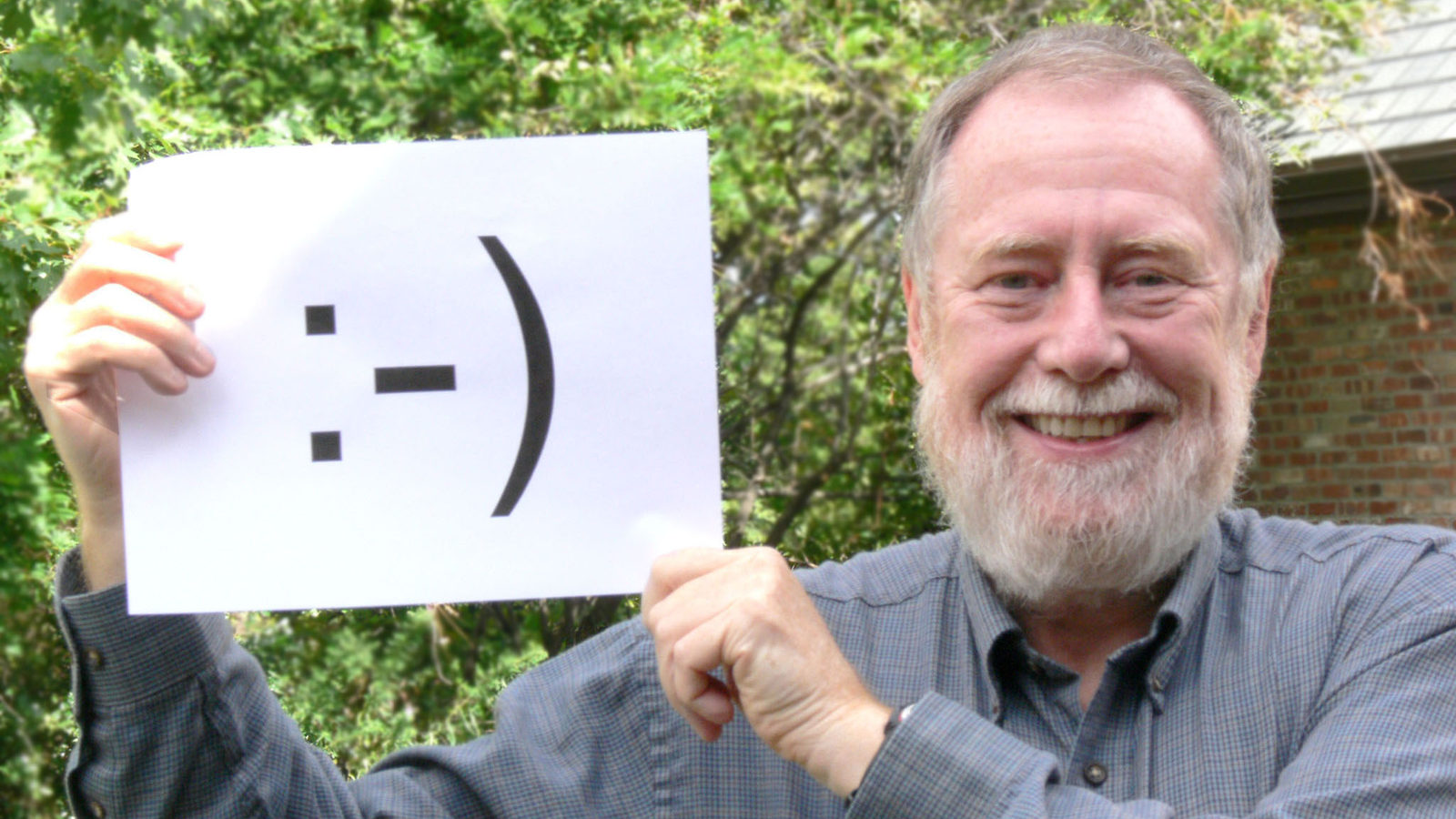 Photo of Scott Fahlman holding smiley face sign