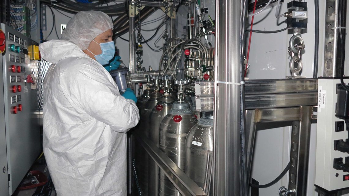 SLAC National Accelerator Laboratory's Jon Davis checks the enriched xenon storage bottles before the refilling of the TPC