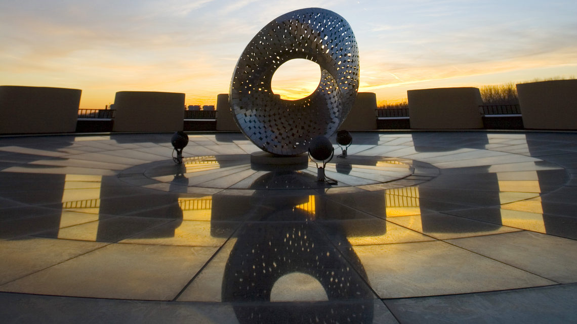 Photo of Fermilab founding director Robert Wilson’s Mobius Strip sculpture atop Ramsey Auditorium