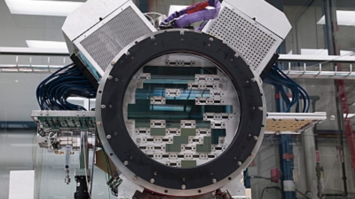 Photo of technicians at Fermilab assembled the Dark Energy Camera in a cleanroom