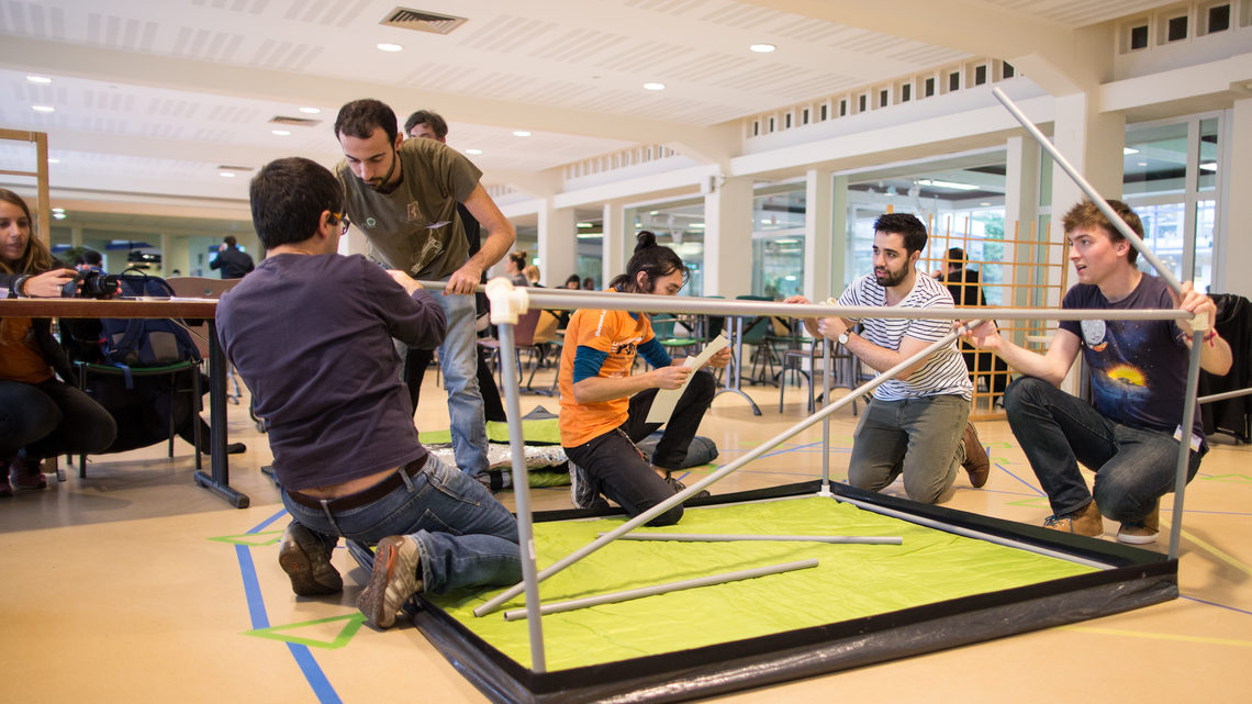 Group of people working on putting a table together