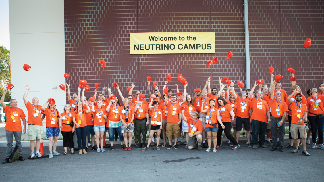 Part of the volunteer team at the neutrino campus breaks from sharing science for an exuberant group photo.