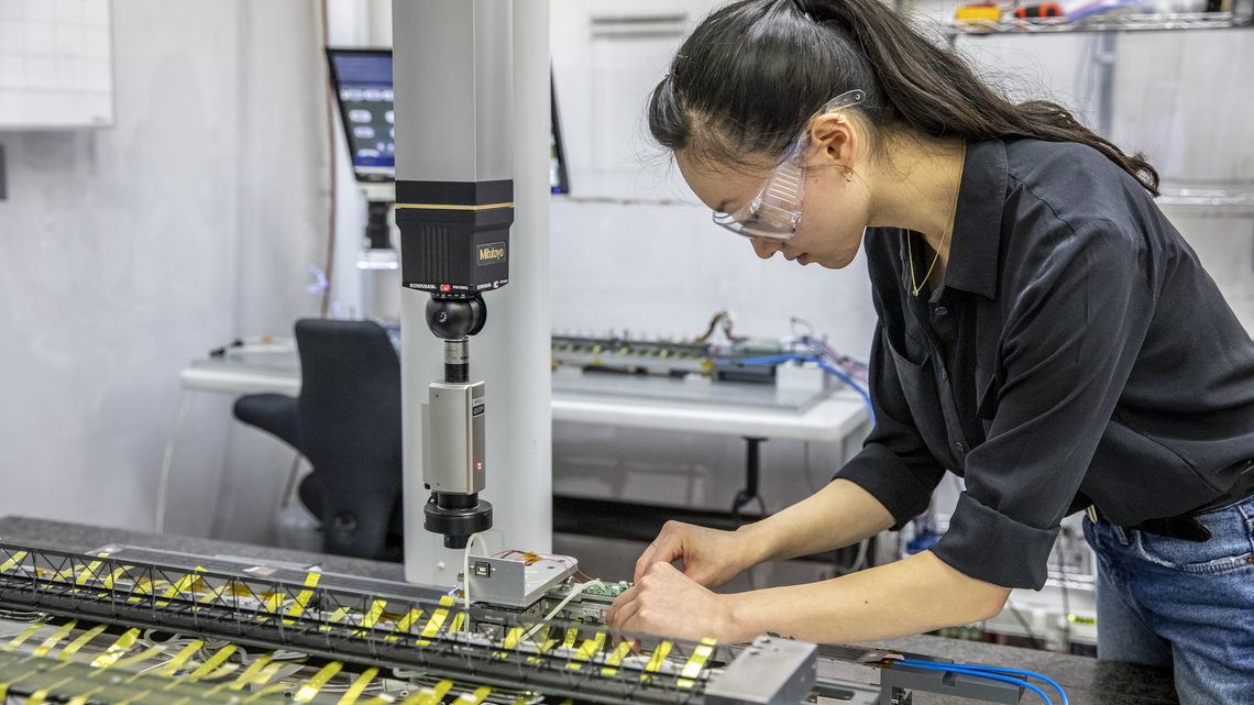 Erica Zhang conducts measurements of a detector stave