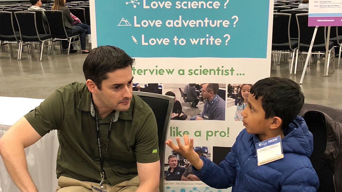 Young interviewer with a scientist