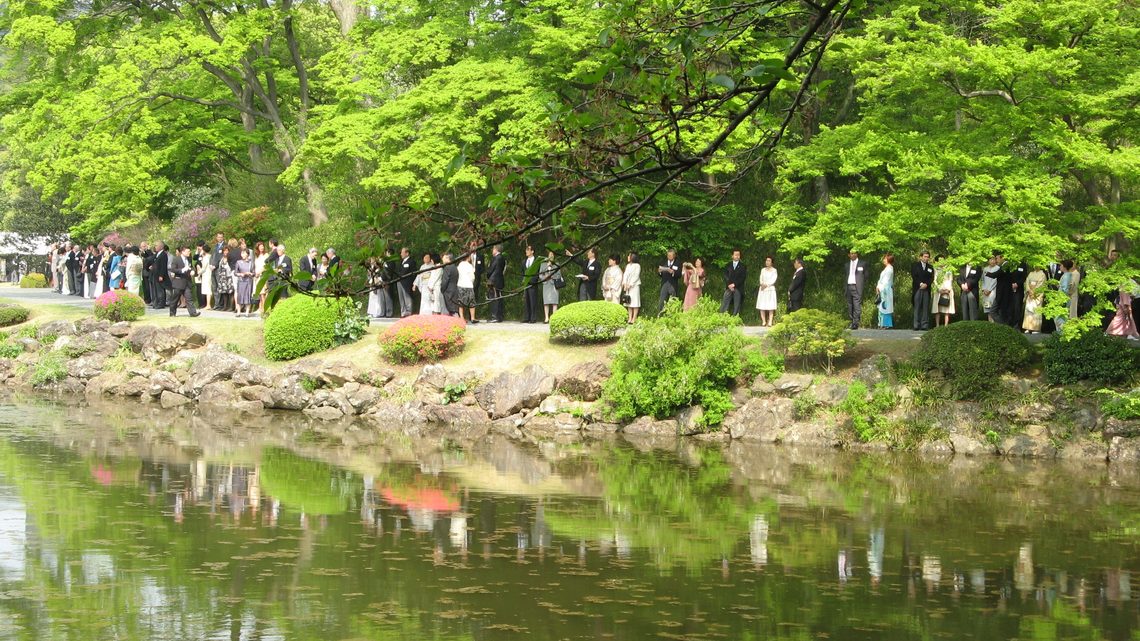 Attendees of the event stand along the water's edge