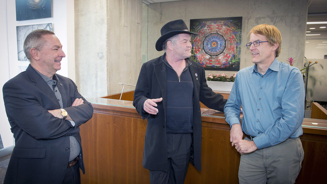 Former Monkee Micky Dolenz talks with the director and deputy director of Fermilab