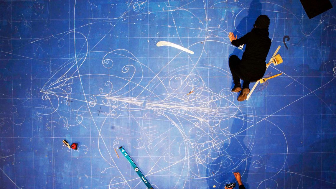 Overhead photograph of artists creating the blueprint