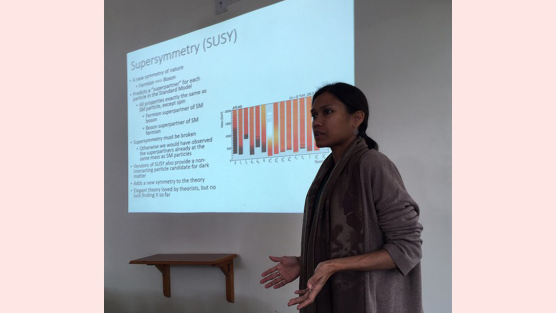 Photo of woman giving a presentation about supersymmetry