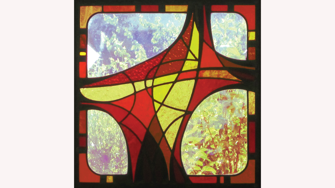 Curved lines stained glass piece in red, yellow, and black
