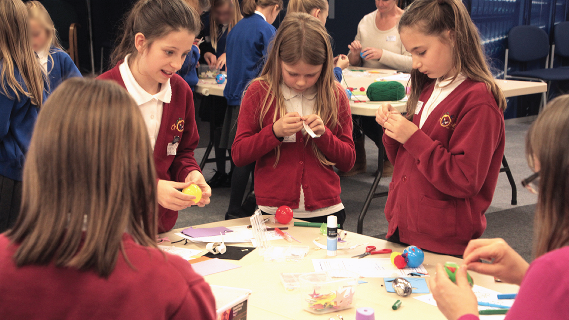 Photo of children making their own dark matter particles during a workshop at STFC’s Rutherford Appleton Laboratory in the UK