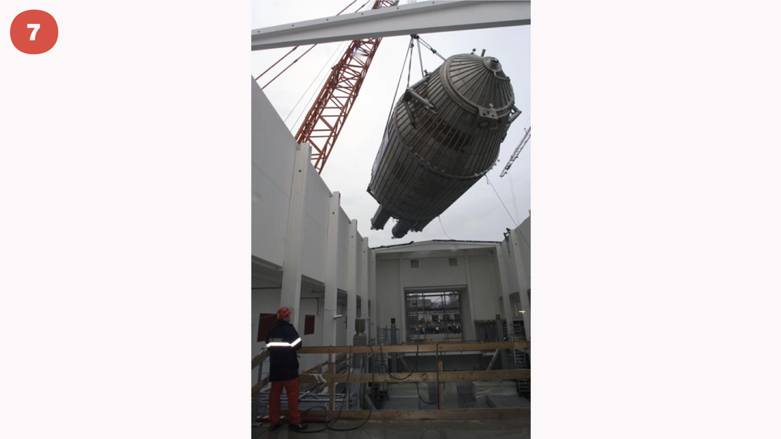Photo of crane, reassembled at the research center, lifting the instrument to its final position through an open roof