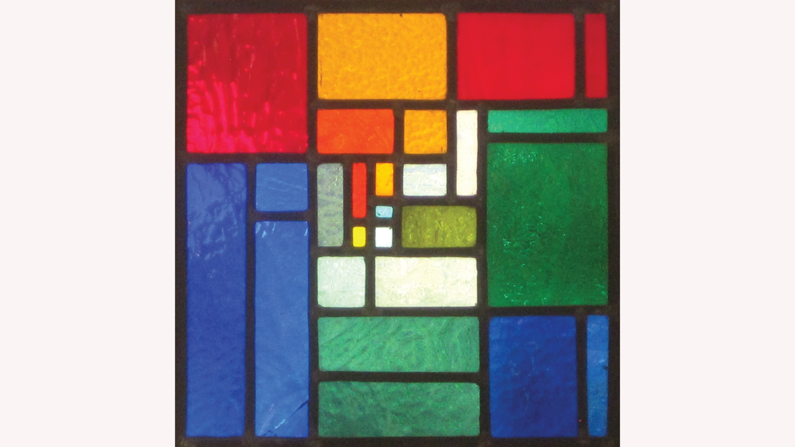 Square stained glass piece in red, yellow, green, and blue