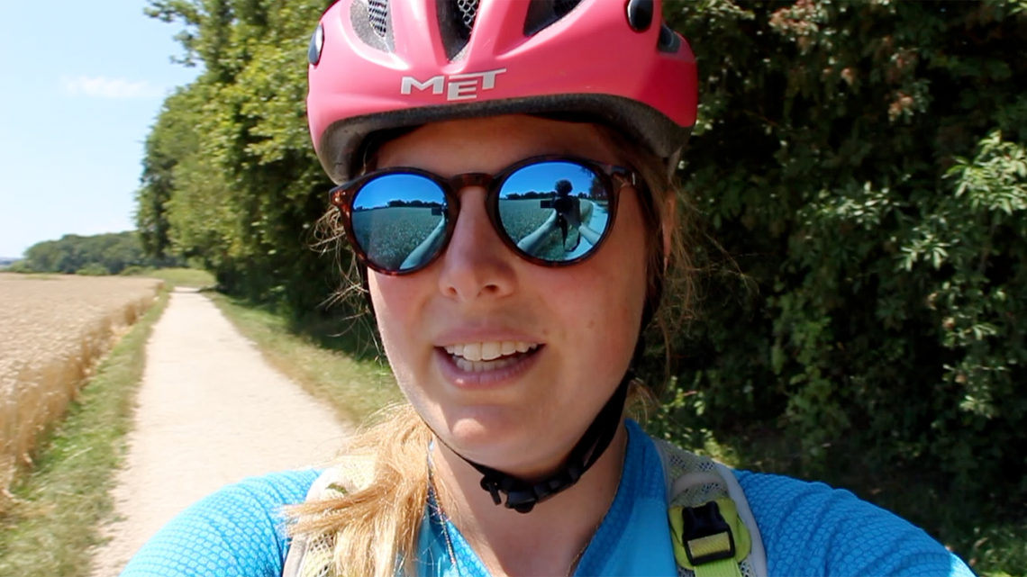 Sarah bikes on a dirt path near the French-Swiss border.