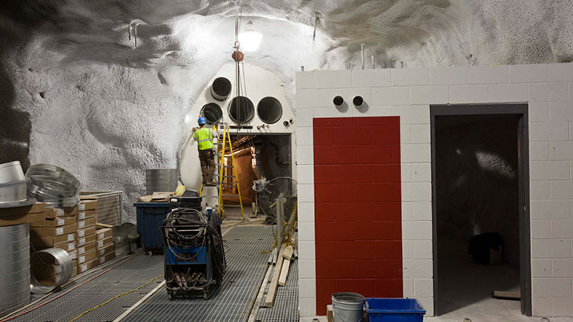 Photo of the LUX control room, at right, is located on the second floor of the LUX detector hall, above the water tank