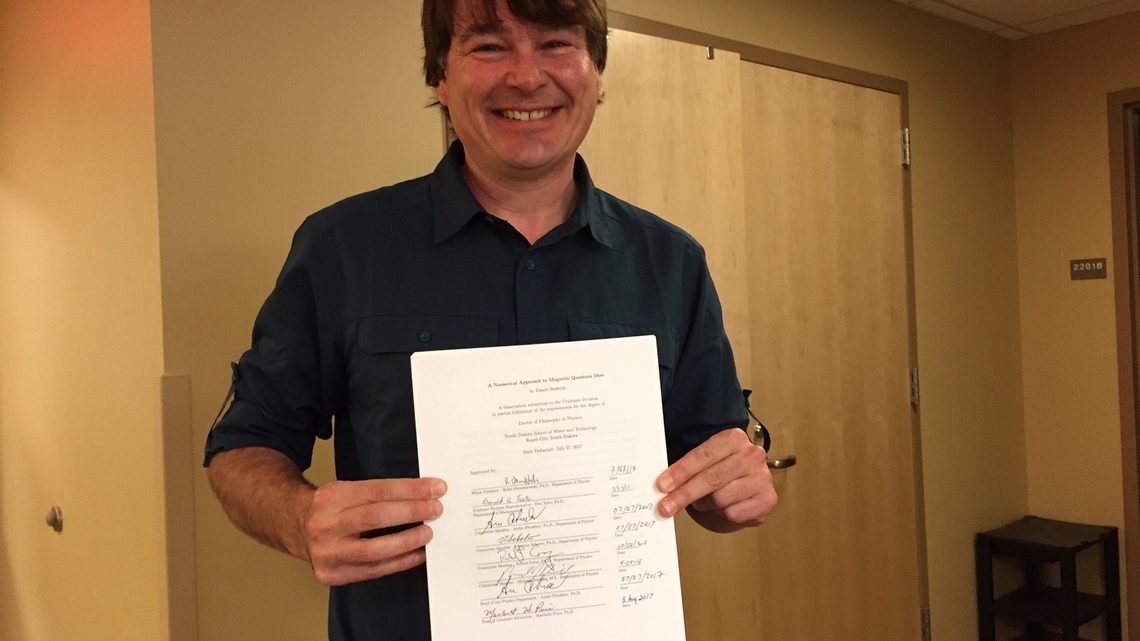 Photo of Dan Rederth and his dissertation