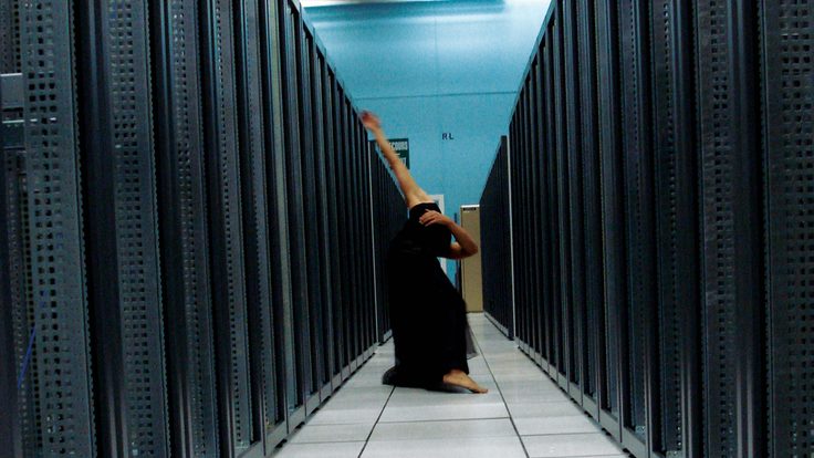 Ben Wegman moves down an aisle of server racks at CERN’s Computer Center.