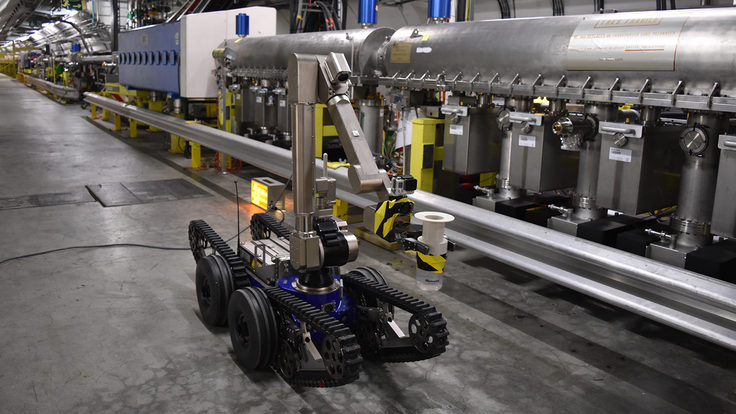 Robot with wheels, an arm and a camera in the tunnel of the Large Hadron Collider