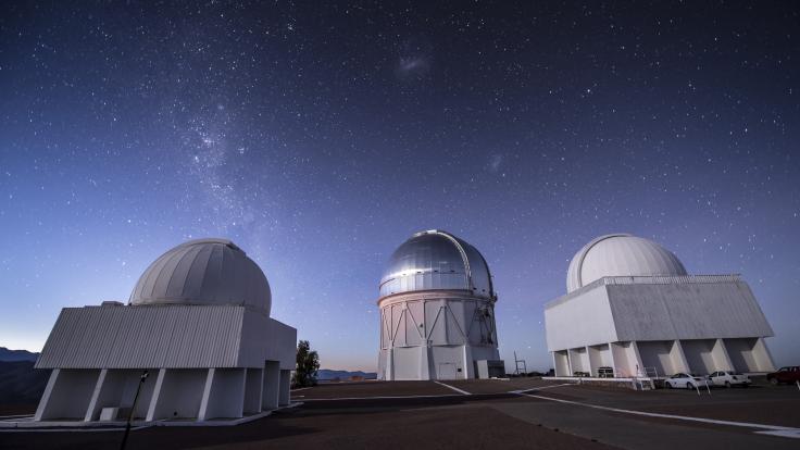 Photograph of telescopes under a starry sky