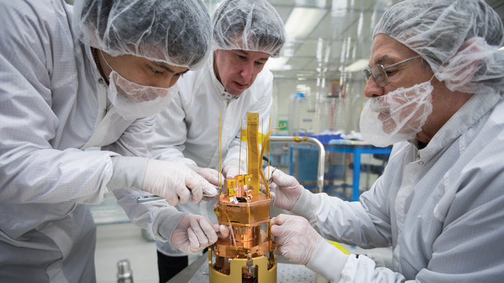 From left: SLAC's Tsuguo Aramak, Paul Brink and Mike Racine are performing final adjustments to the SuperCDMS SNOLAB engineering