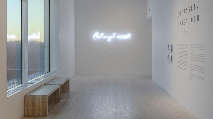 A neon sign reading 'entanglement'
