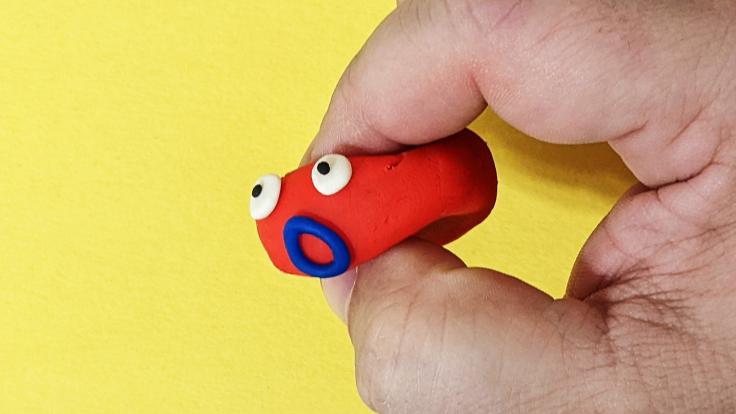 A Play-Doh head being squished