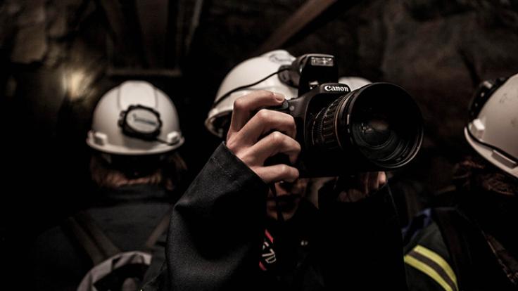 Photo of person with camera underground