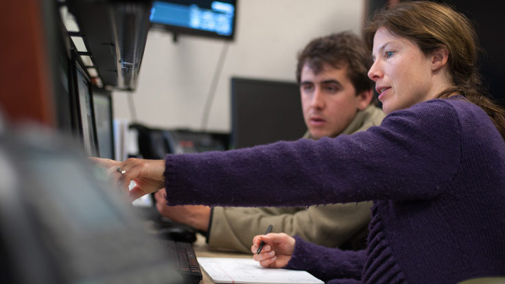 Photo of LCLS engineering physicist Silke Nelson, right, shows intern Tyler Couto how to operate a controls system