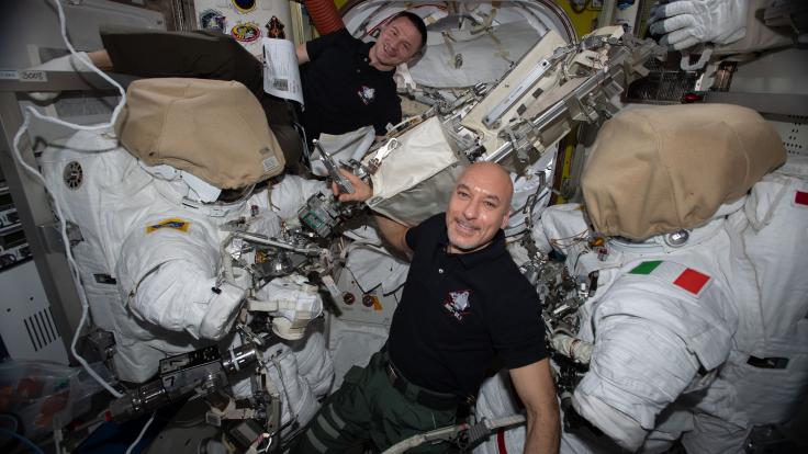 Two astronauts with their spacesuits 